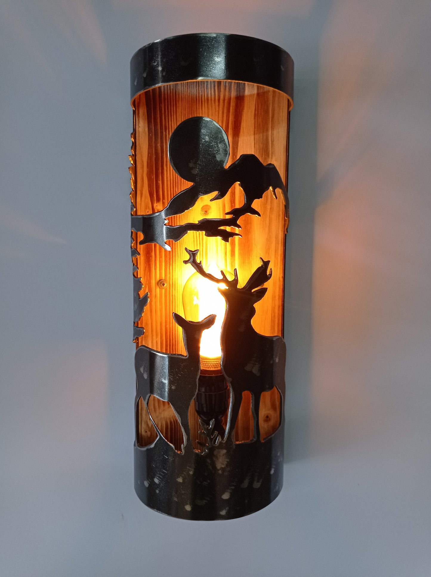 Rustic wall light with deer silhouette cutout, woodland cabin bedroom sconce