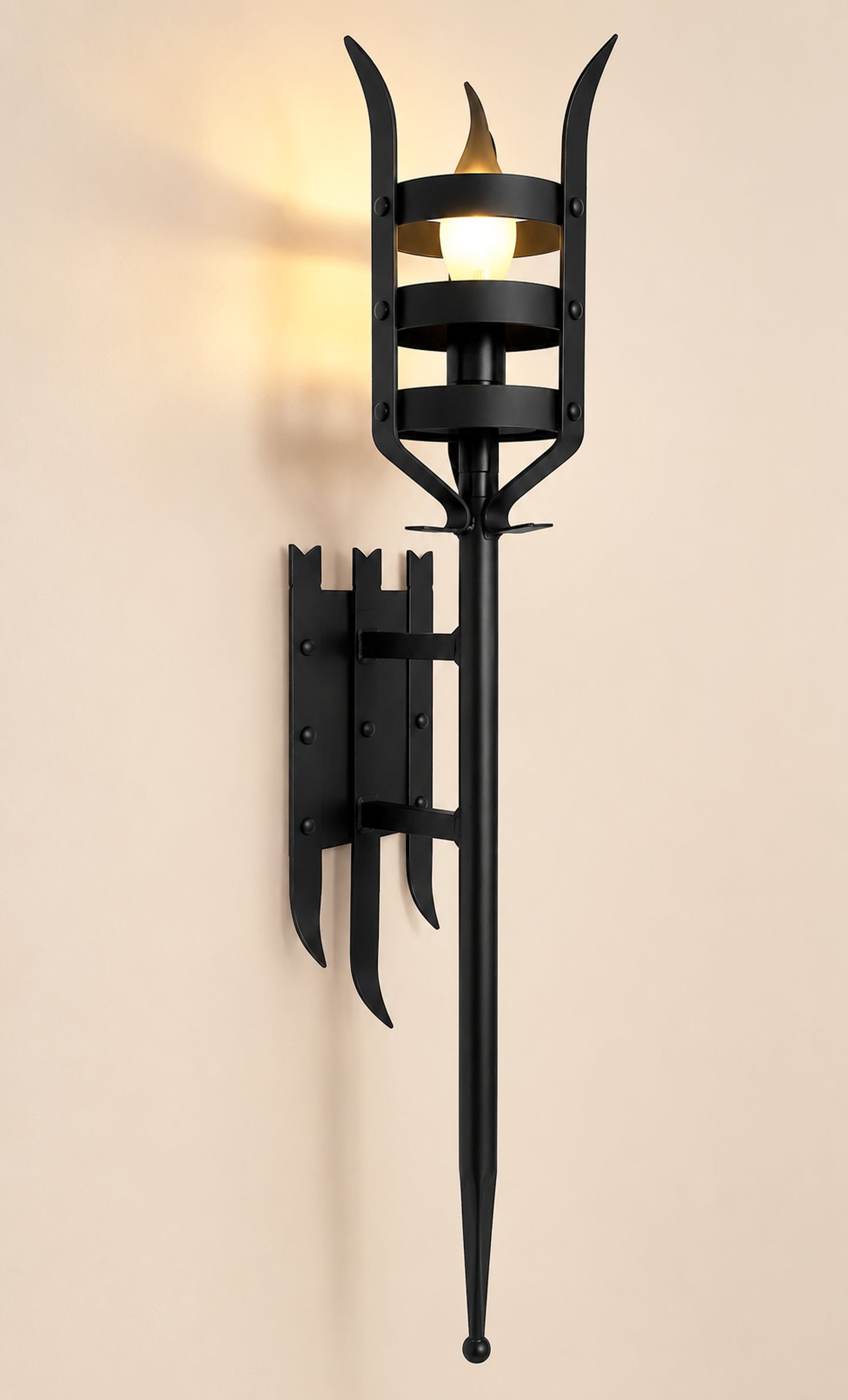 Black wall-mounted outdoor light fixture on a beige background