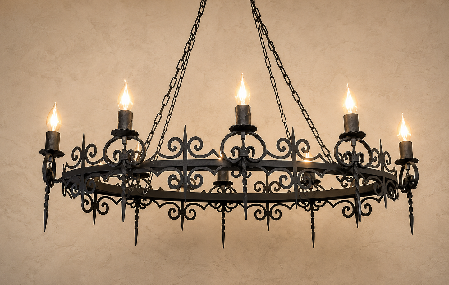 Wrought iron chandelier with candle-style lights on a beige wall.