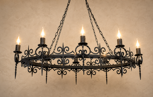 Wrought iron chandelier with candle-style lights on a beige wall.