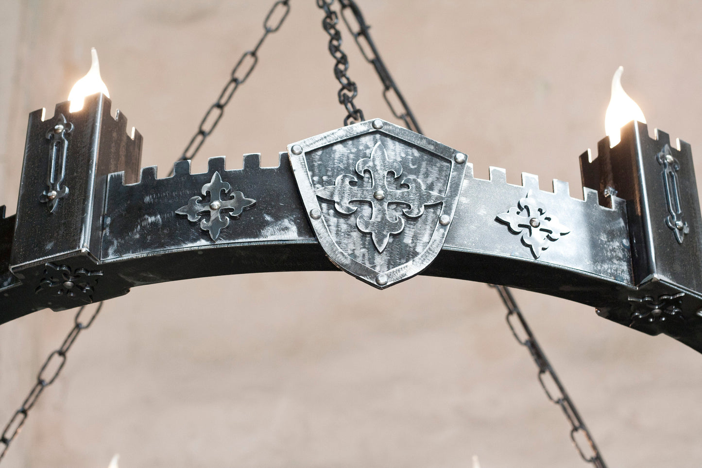 Medieval iron chandelier crenellated towers close up