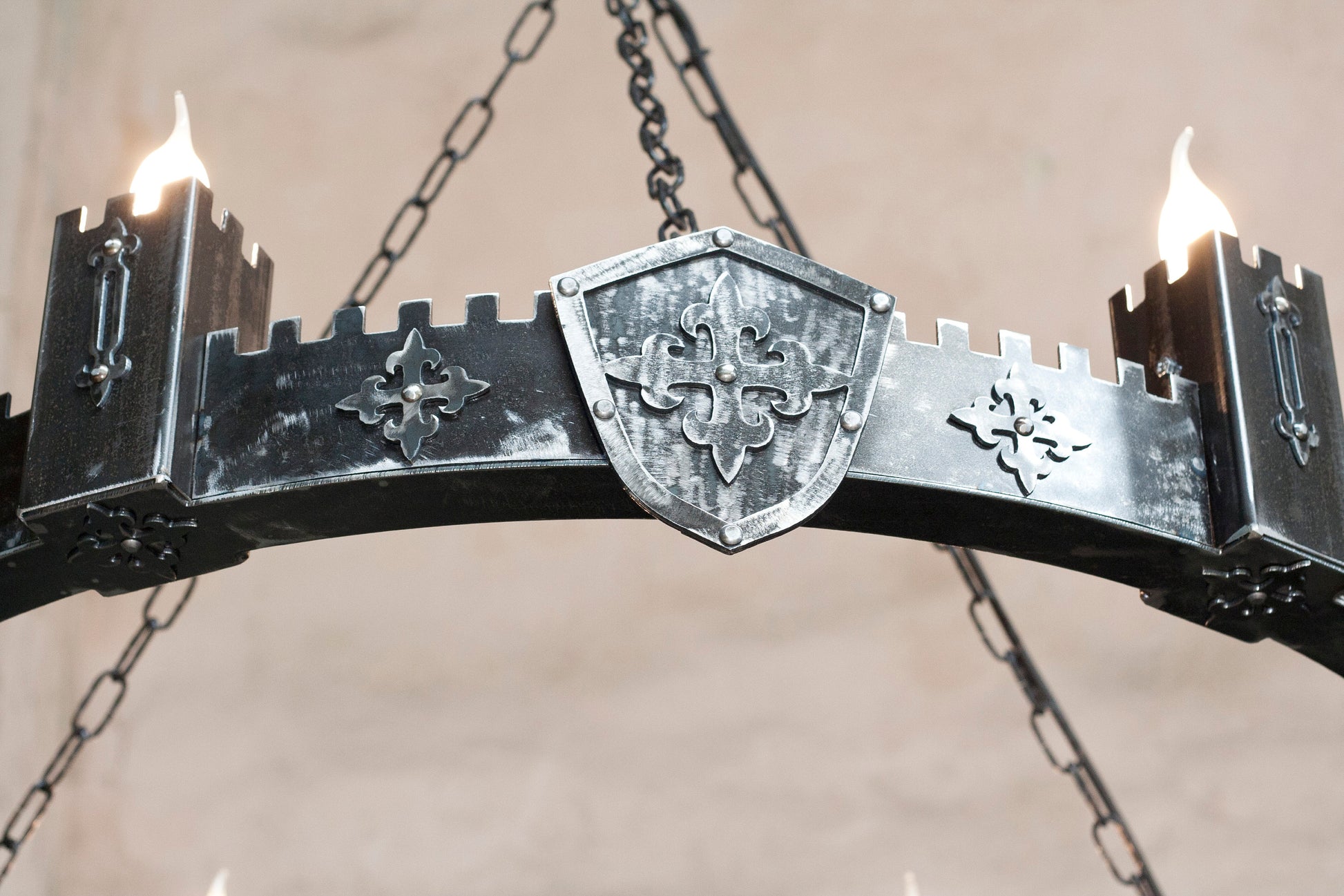 Medieval iron chandelier crenellated towers close up