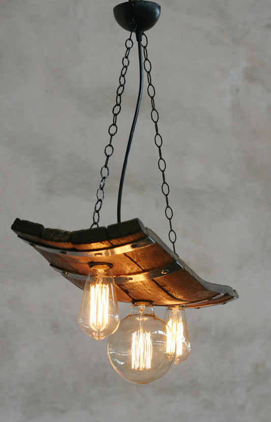 A rustic barrel-shaped ceiling light with three bulb holders and an adjustable chain, finished in a natural wood color.