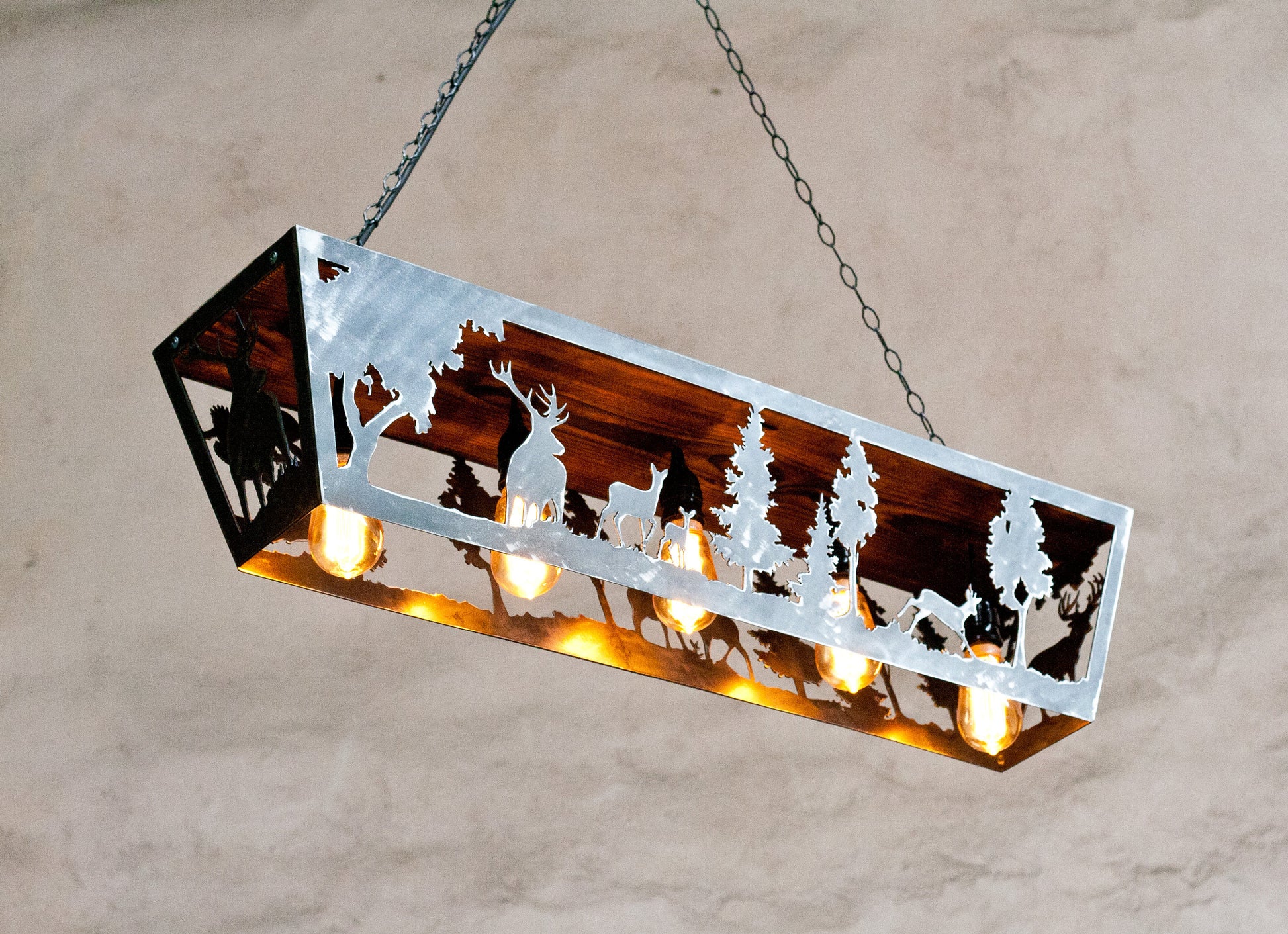 Rustic ceiling light fixture with a wildlife pendant design, featuring five lights and a ceiling mount.