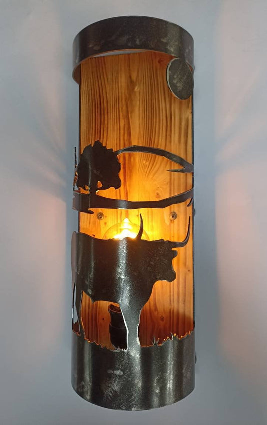 Rustic longhorn wall sconce with burnt wood backing and brushed steel silhouette, cabin lighting