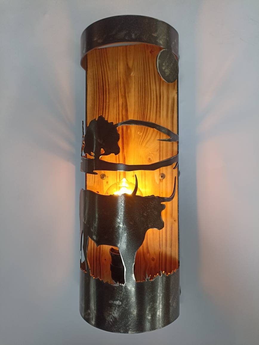 Western cabin wall sconce with hand-cut longhorn design, four finish options