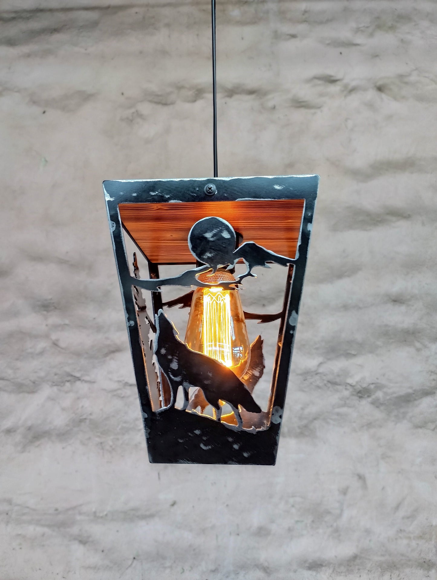 Hand cut wolf silhouette pendant light close up