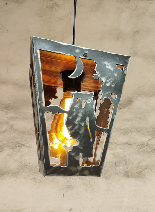 Rustic pendant light with an owl design, made out of wood and steel with a clear varnish coating, showing visible rust and aged finish.