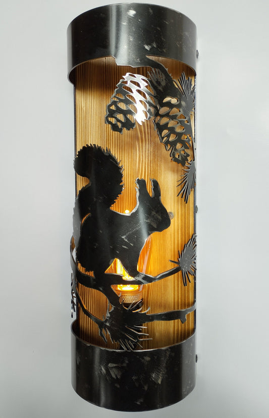 A rustic wall light fixture with a silhouette of a squirrel and pine cones, made of wood and metal with a clear coat finish.
