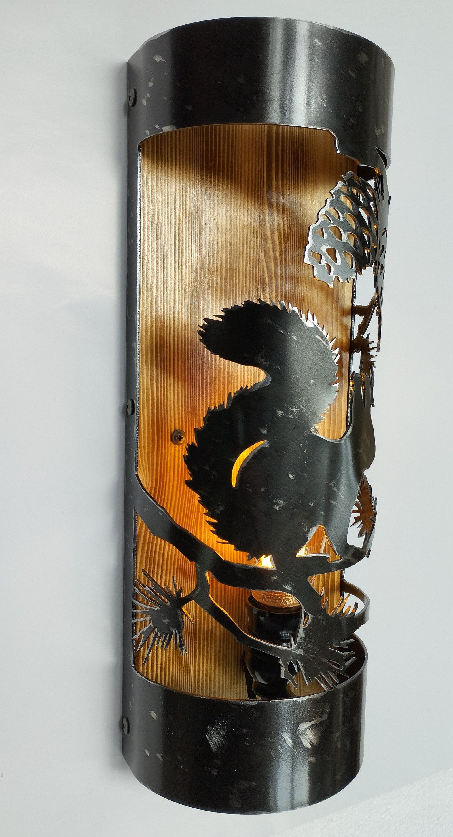 Rustic squirrel cottage wall light illuminated amber bulb