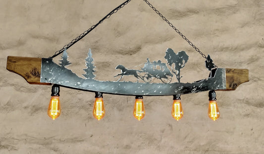 Rustic ceiling light fixture with a stagecoach and trees design, made of wood and steel, with visible bulb holders and chain for adjustable height.